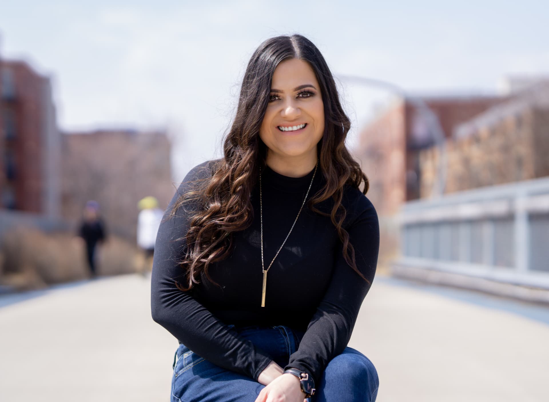 Maria Gutierrez smiling outdoors in Chicago, founder of MG Ascend Realty Inc